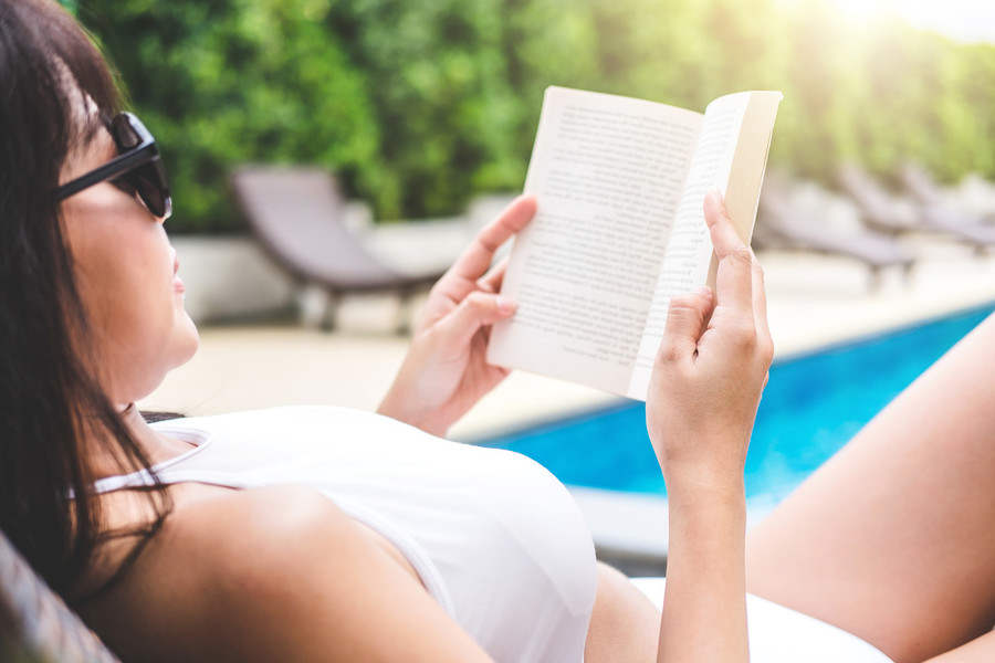 Sun, sand, and books! Are we reading more by the pool?